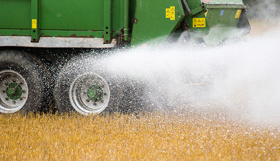 Kipsiä levitetään pellolle traktorilla.